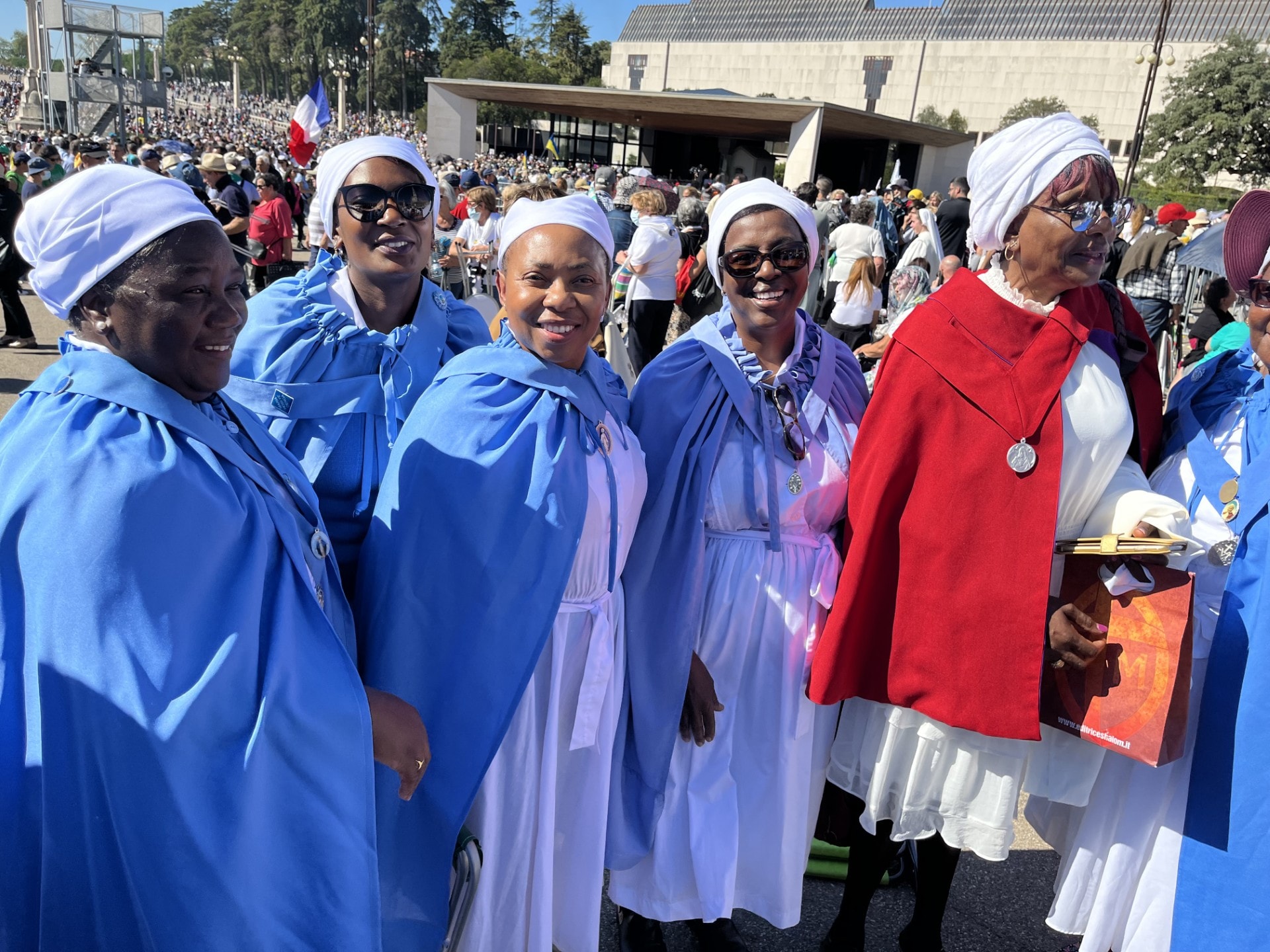 Group of pilgrims in blue robes gathered together on a Travel406 journey